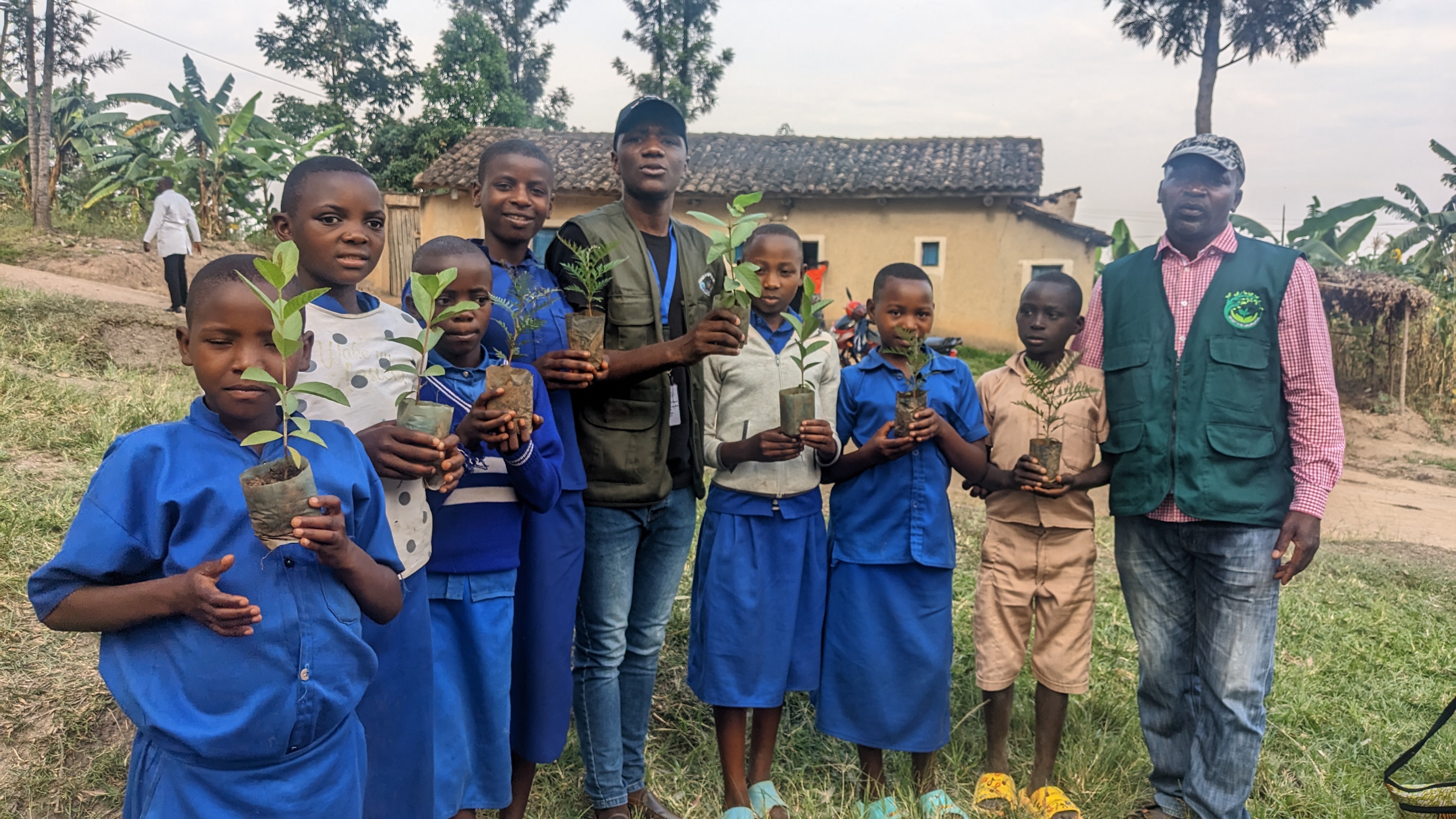 Students holding seedlings during Green for Life Rwanda environmental education activities